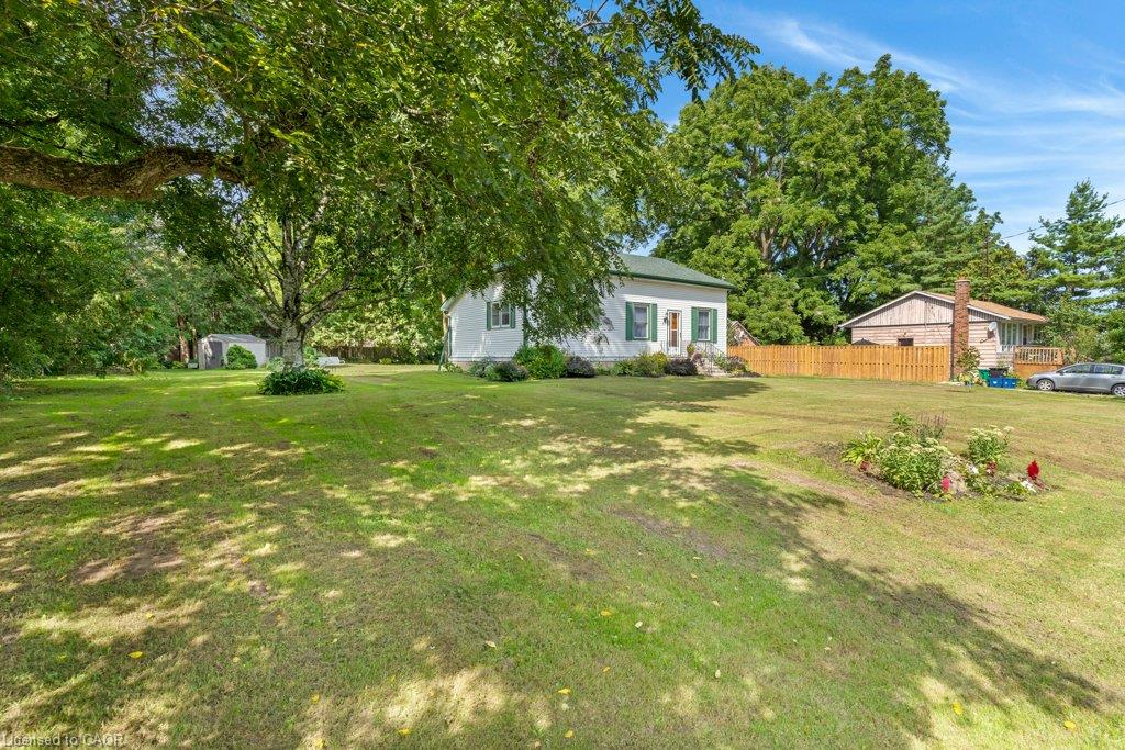 Expansive level lot with mature shade trees and manicured lawn
