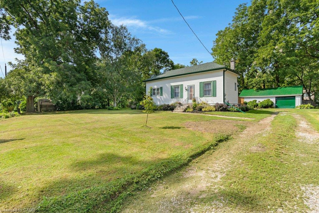 Charming single-story residence set on expansive grounds with mature shade trees and manicured lawn