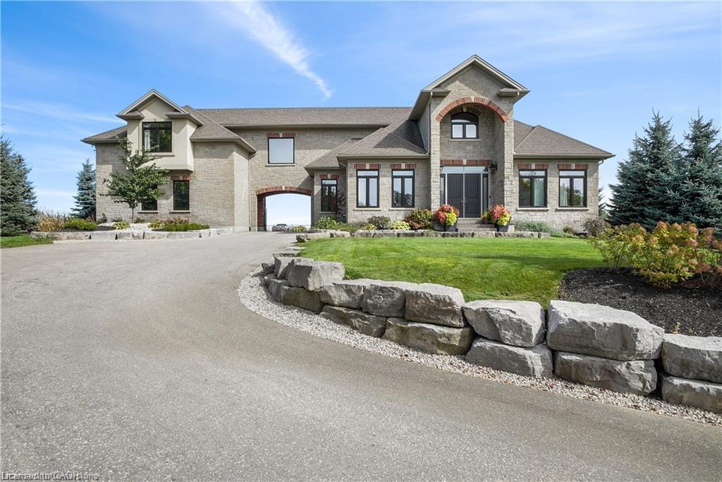 View of front of property with a garage and a front yard