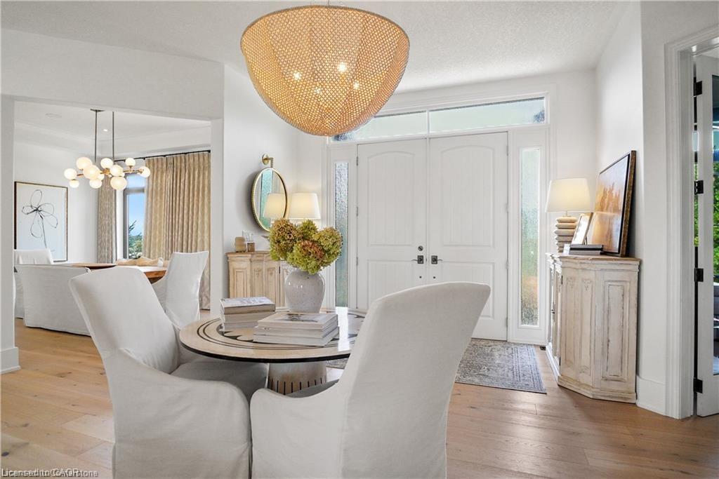 Dining space featuring a chandelier, a textured ceiling, light hardwood / wood-style flooring, and a healthy amount of sunlight