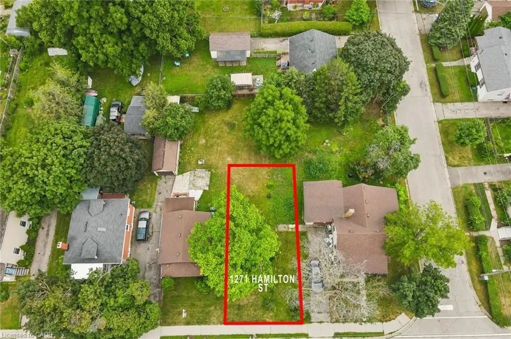 Expansive lot featuring mature tree coverage and lush landscaping throughout