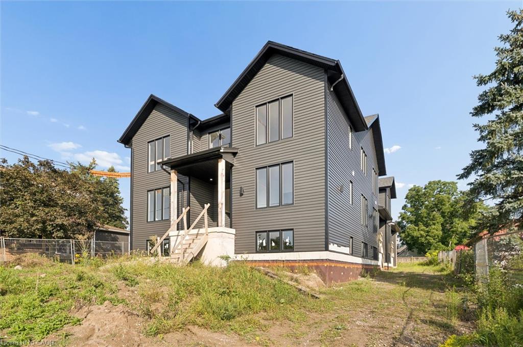 Modern exterior featuring dark gray siding, multiple gabled rooflines, and black-framed windows