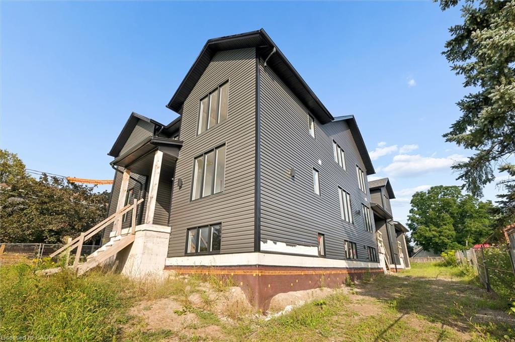 Contemporary exterior with dark siding and multiple large windows