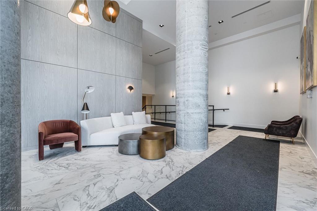 Lobby interior featuring large format marble-look flooring and a prominent exposed concrete column