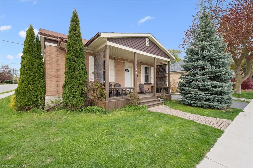 Brick exterior with a covered front porch and a paved walkway