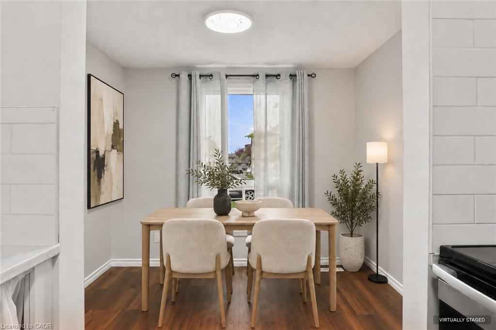 Wood-finish flooring with a flush-mount ceiling light and a window featuring dark curtain rods