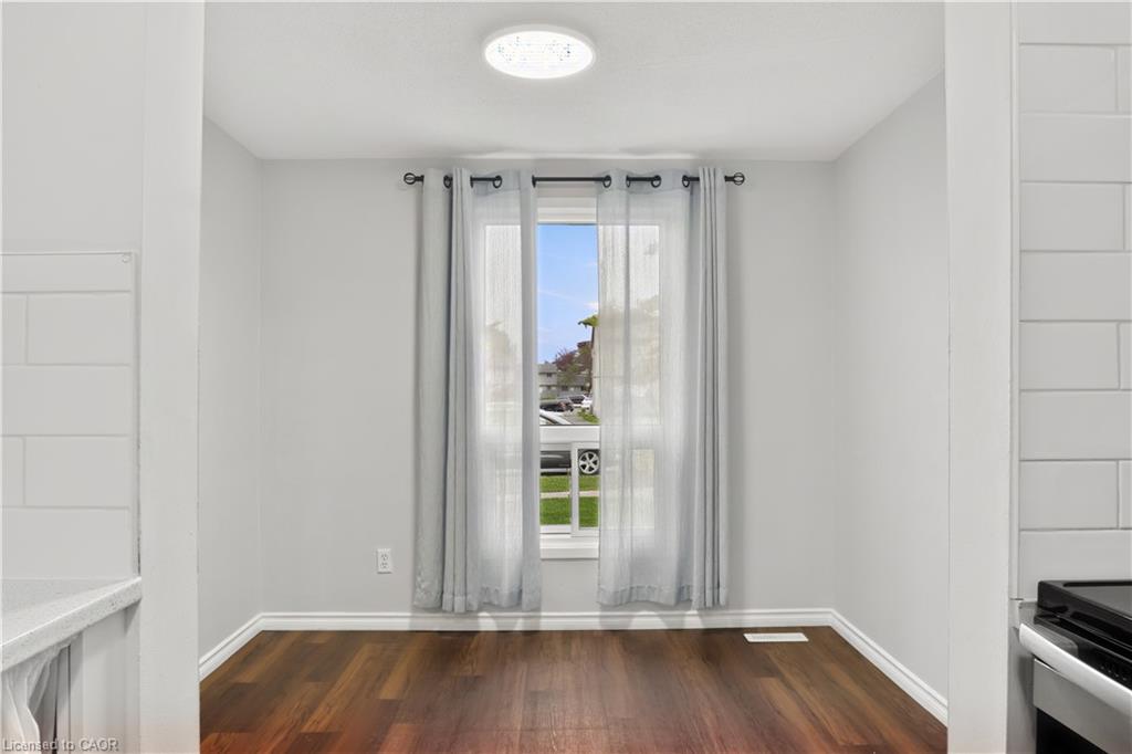 Wood-finish flooring, recessed lighting, and large windows