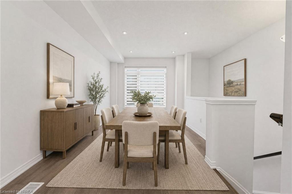 Recessed lighting, wood-finish flooring, and a large window with horizontal blinds