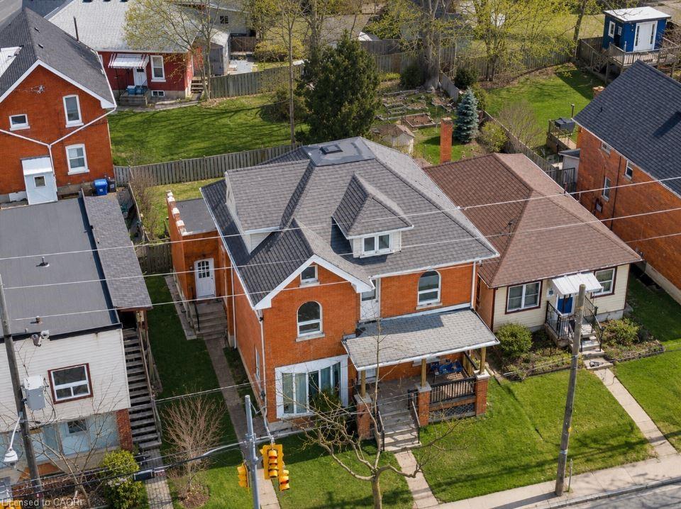Brick exterior with a multi-level roofline, featuring a covered front porch and a dormer window