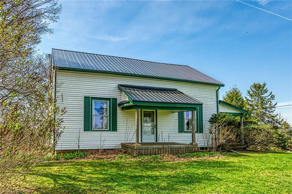 White siding exterior with a dark metal roof