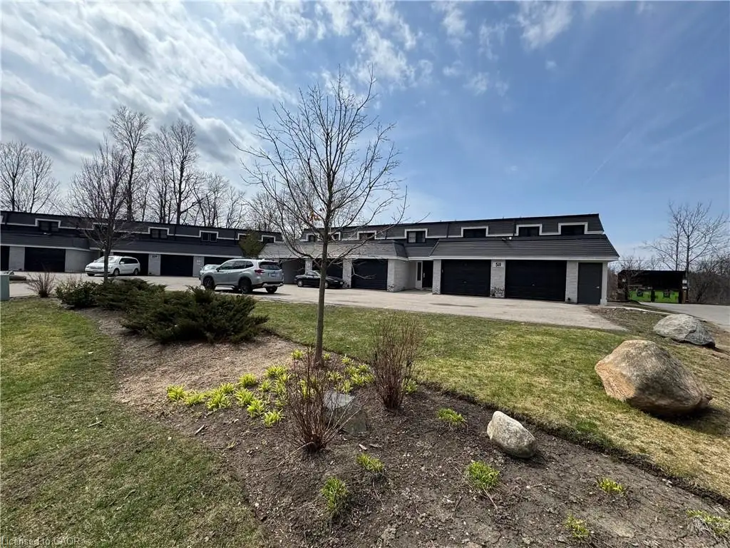 View of front of property featuring driveway and a front yard