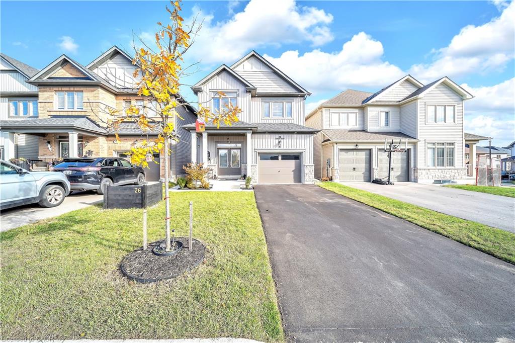 Contemporary two-story residence with a single-car garage, gray siding exterior, and a paved driveway