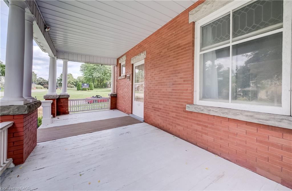 Brick exterior with a covered porch featuring white columns