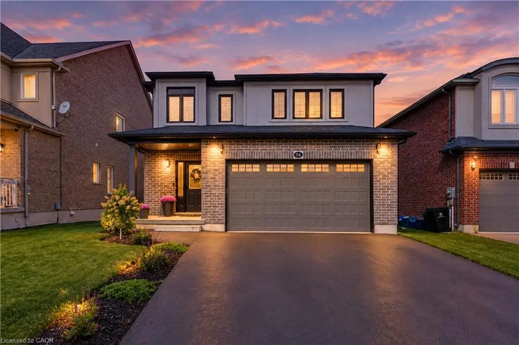 Brick and stucco exterior with a dark asphalt driveway