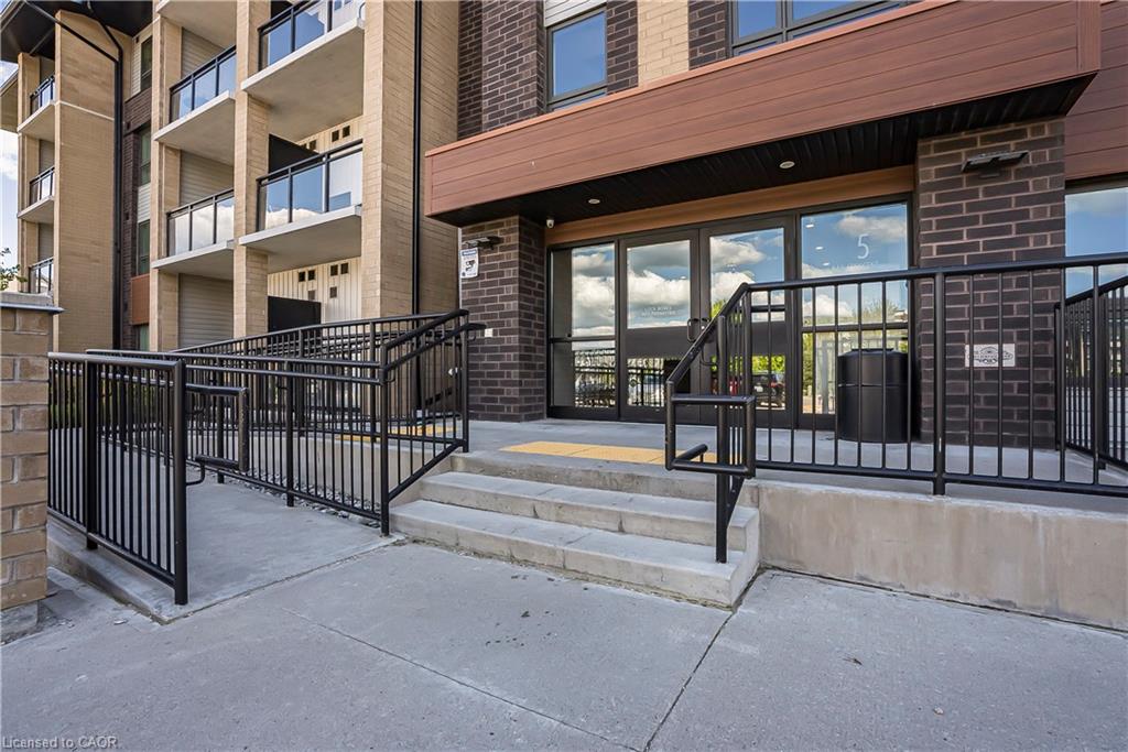 Building exterior featuring a brick facade with a contrasting wood-look accent panel above the entrance