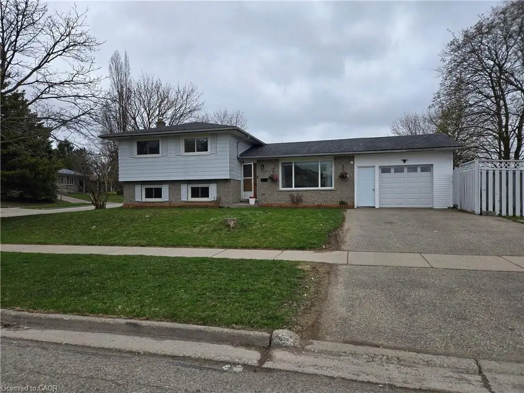 Split-level residence featuring a single-car garage and a paved driveway