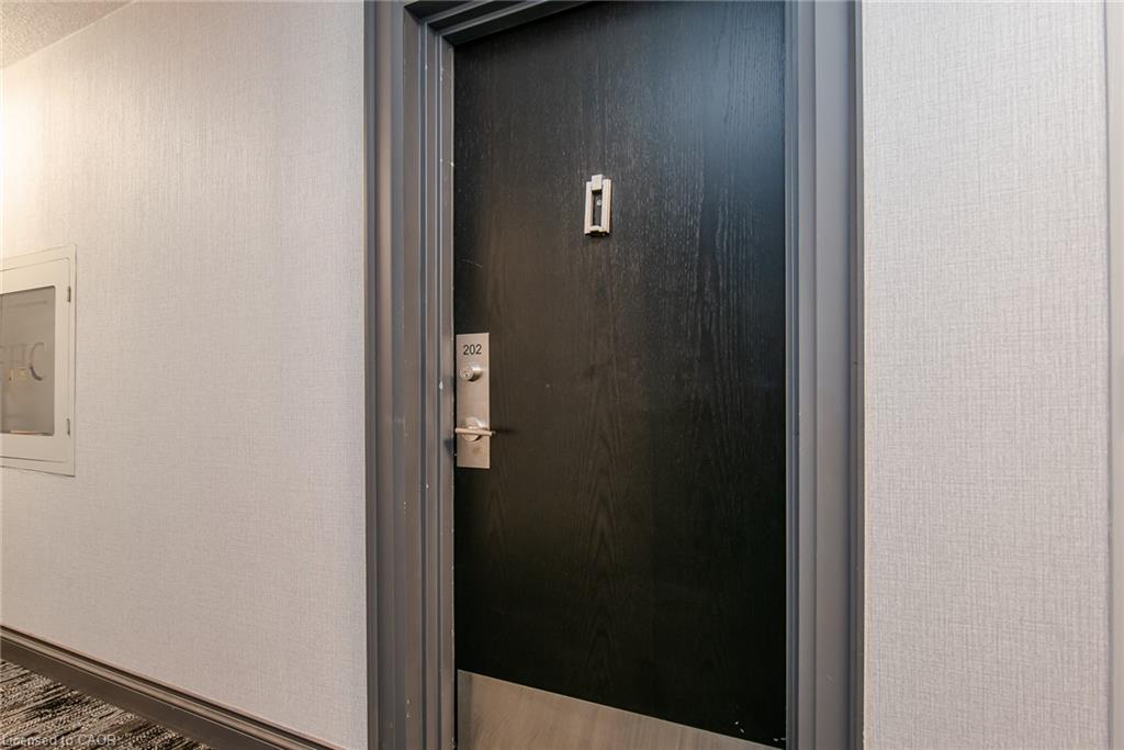 Black wood-grain finish door with brushed metal hardware, set within a gray trim