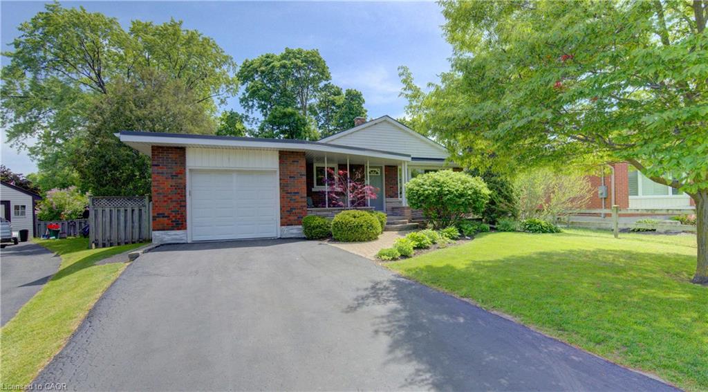 Brick facade home with an attached single-car garage and a paved driveway