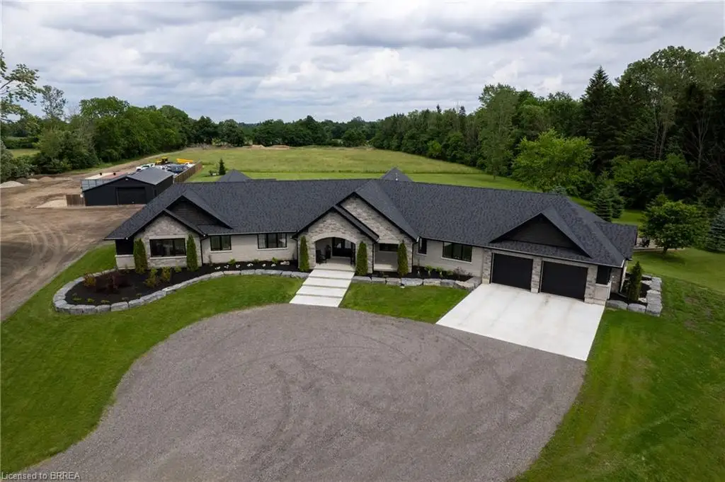 Stone and siding exterior with a dark shingle roof