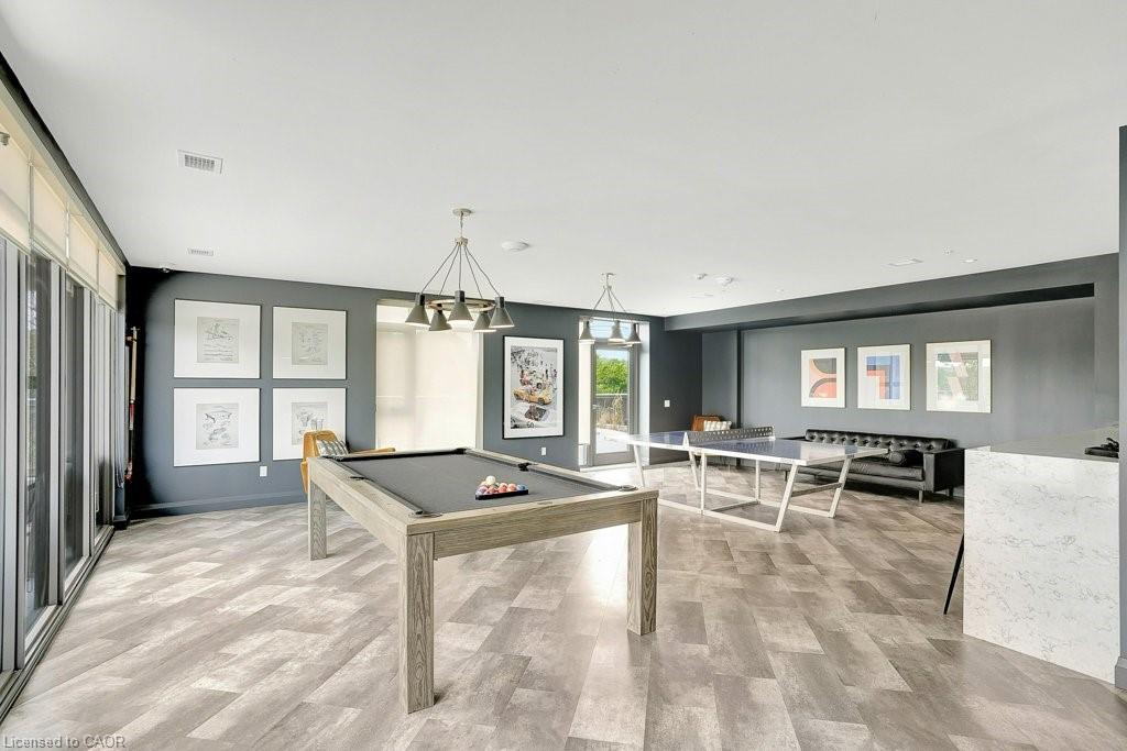 Playroom with pool table and light wood finished floors