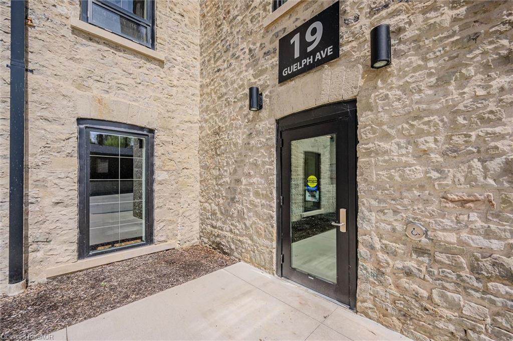 Stone exterior with black-framed windows and a glass-paneled entry door