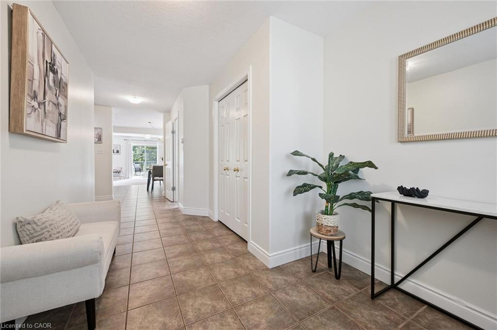 Welcoming foyer showcasing wood-finish flooring, white painted trim, and abundant natural light
