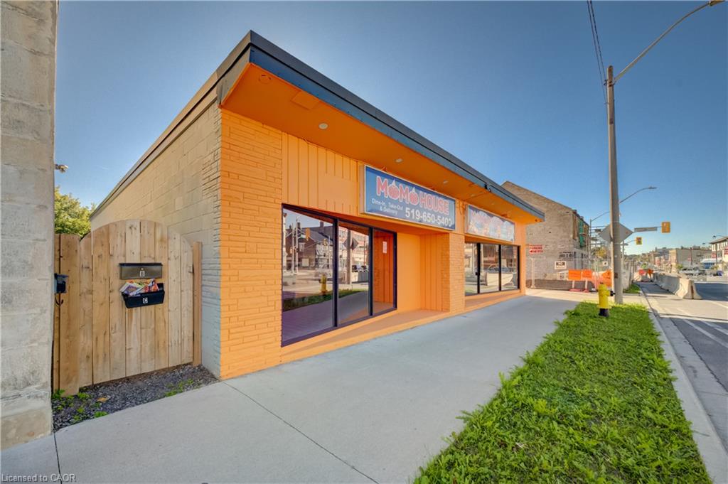 Commercial storefront with large display windows, painted brick exterior, and a flat roof