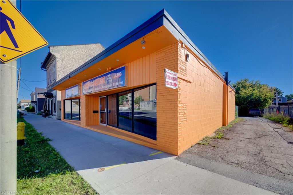 Commercial building featuring an orange brick facade and horizontal wood-finish siding