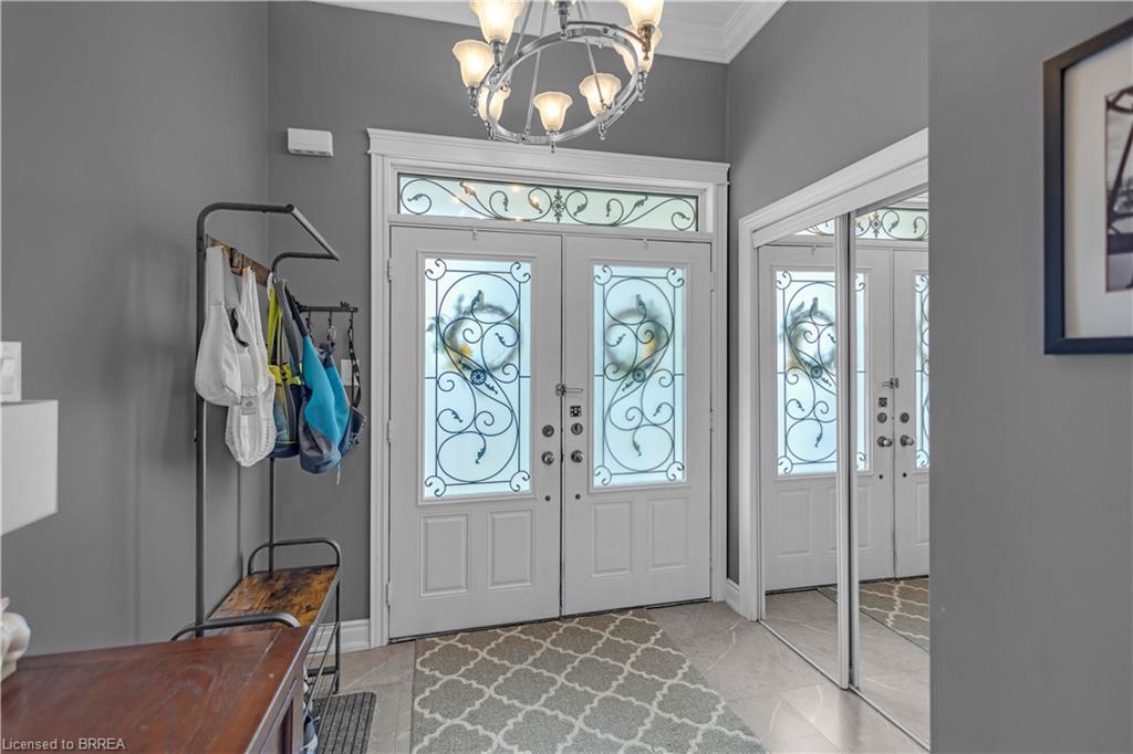 Double entry doors with decorative ironwork, frosted glass, and an arched transom window