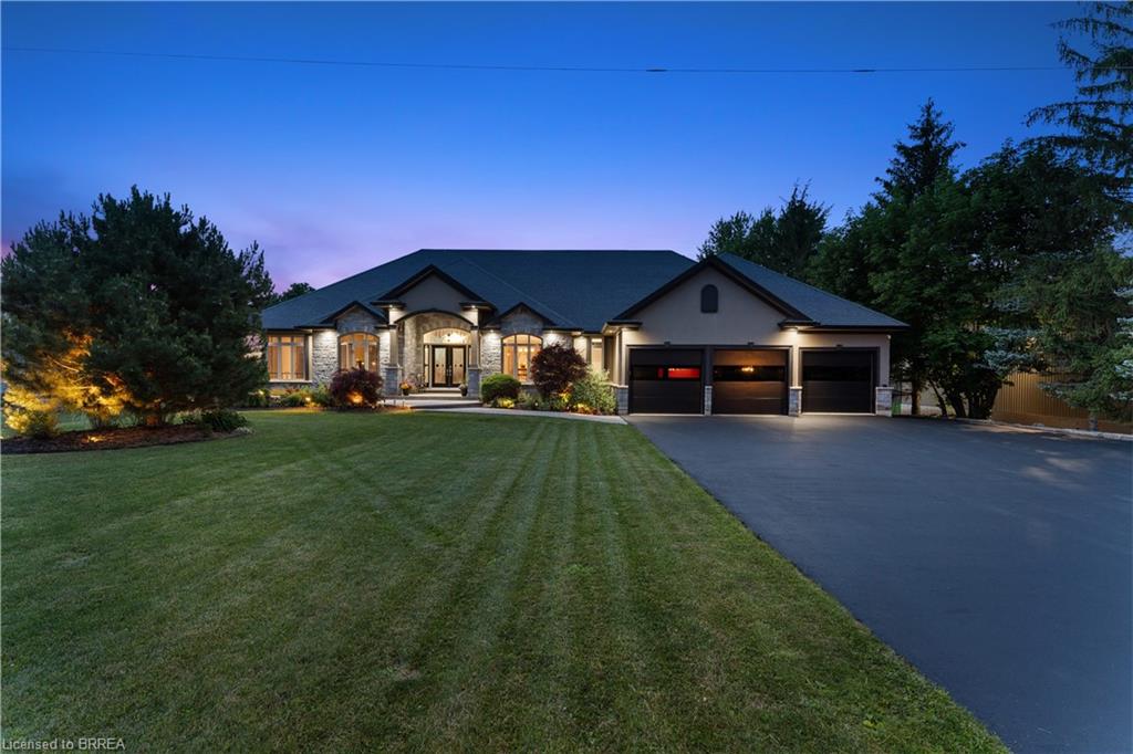 Stone and stucco exterior with a three-car garage