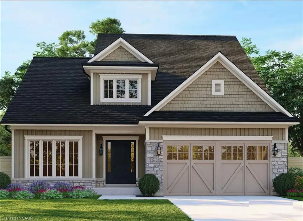 Exterior facade featuring stone veneer siding, decorative shingle-patterned gables, a covered entryway, and a dual-bay garage with carriage-style doors