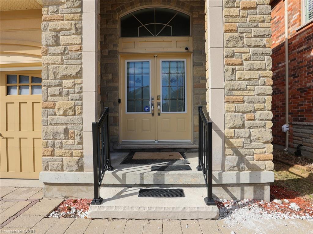 Stone veneer facade with prominent columns framing the main entry