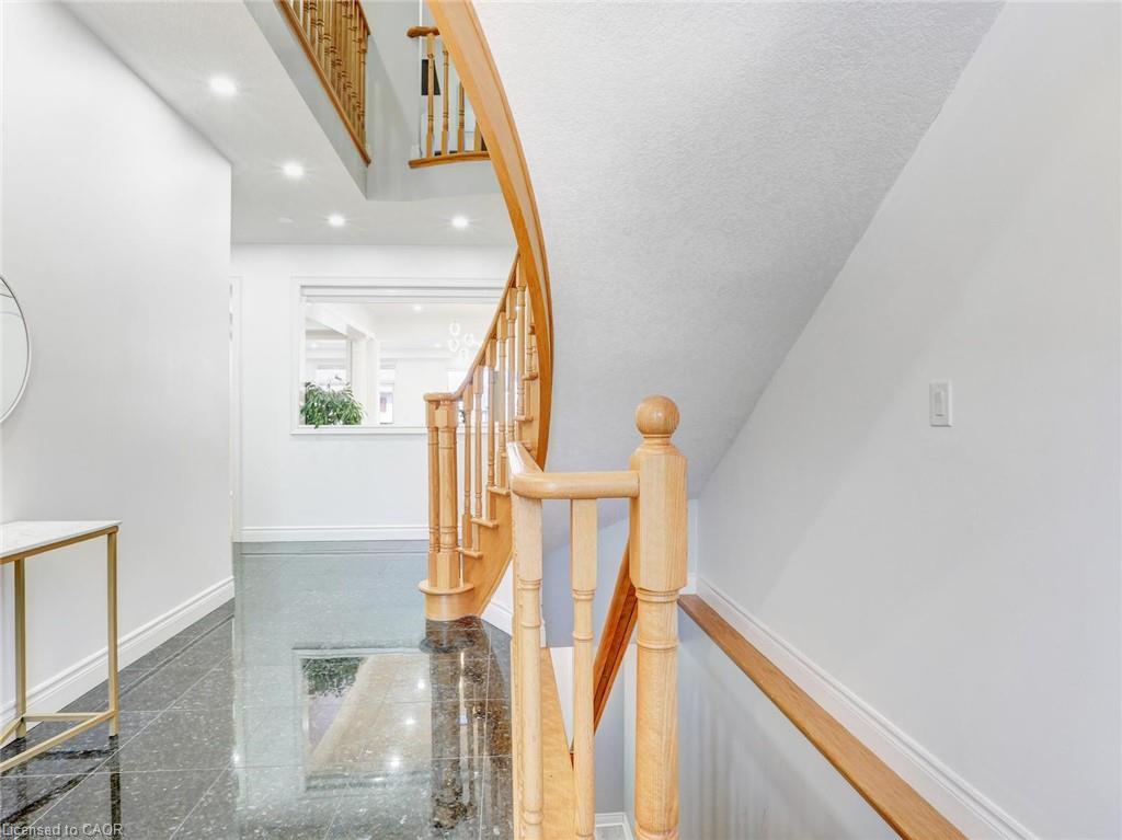 Curved natural wood staircase with balusters and handrail