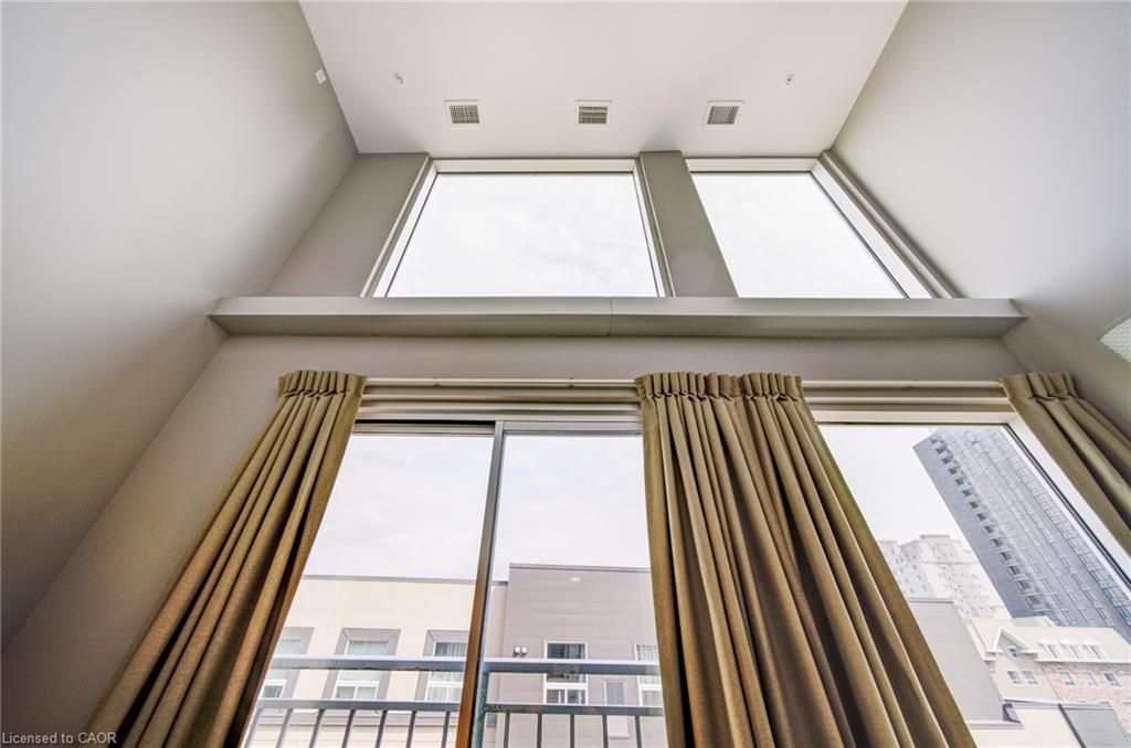 Vaulted ceiling with multiple upper windows and a lower sliding glass door