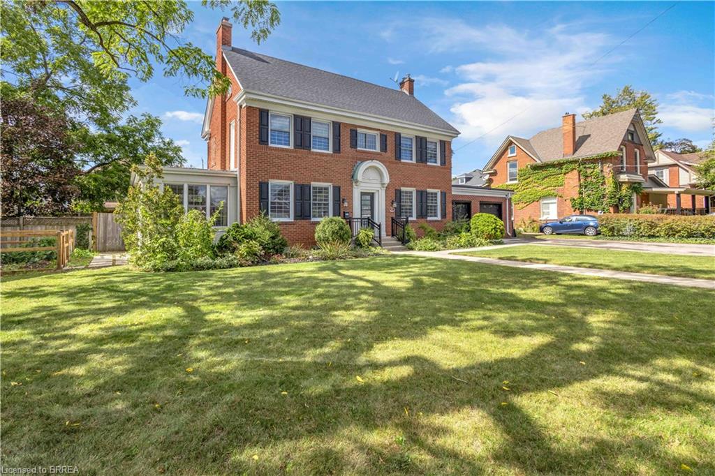 Brick exterior with white window trim and black shutters