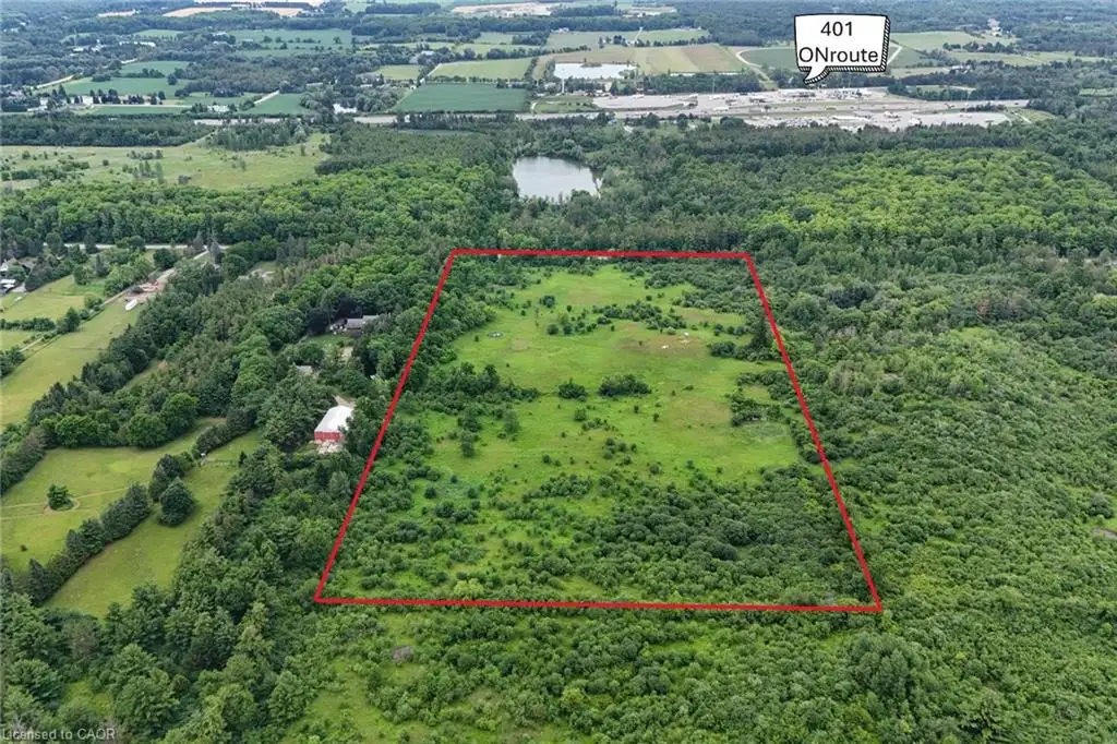 Expansive land parcel featuring a mix of open fields and mature tree coverage