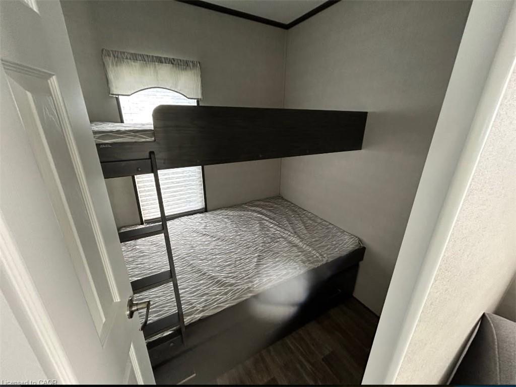 Bedroom featuring dark wood-style flooring