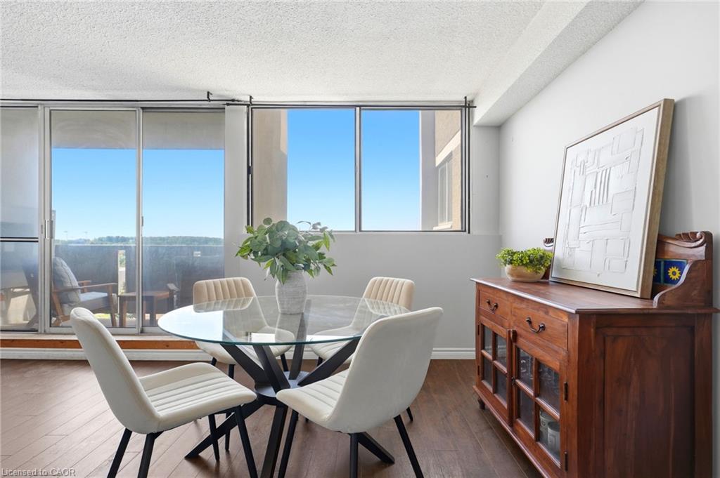 Wood-finish flooring throughout, bright interiors with large windows, and a glass-paneled sliding door opening to an outdoor space