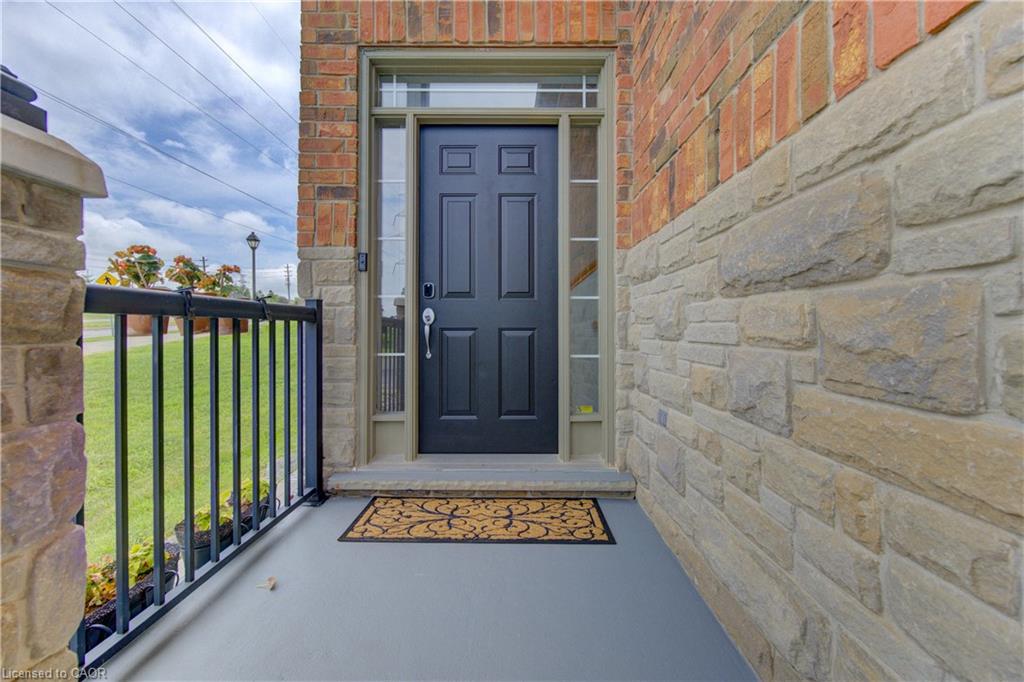 Property entrance featuring a paneled black door, sidelight windows, and transom window