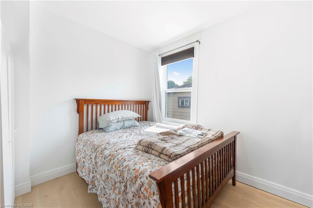 Single-pane window, wood-finish flooring, and white painted walls