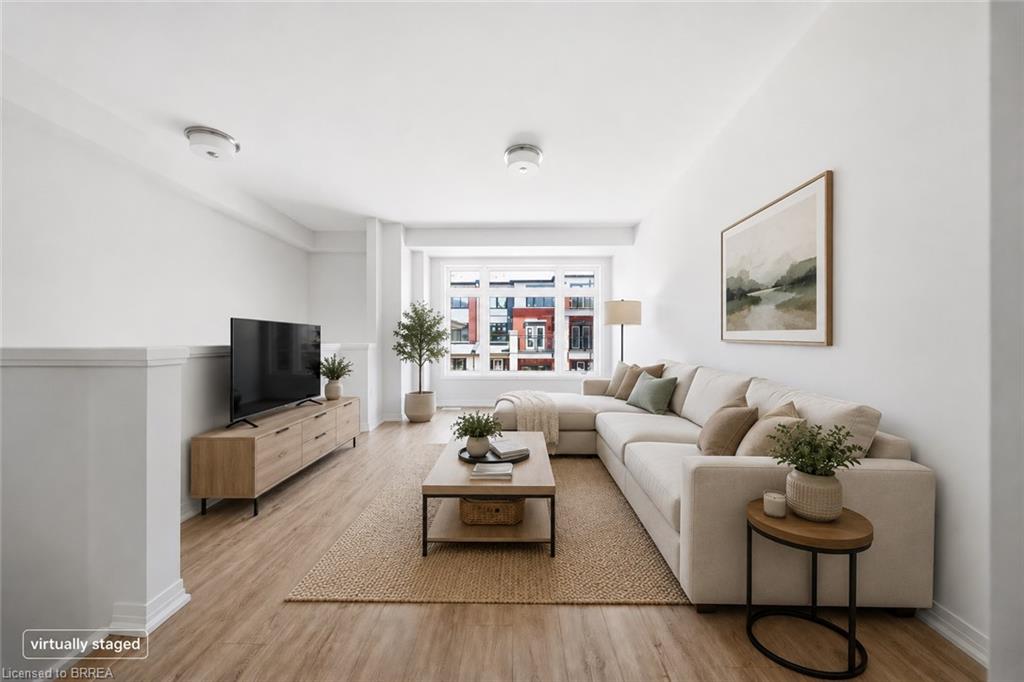 Recessed lighting, wood-finish flooring, half-wall architectural detail, large window, and light neutral wall color