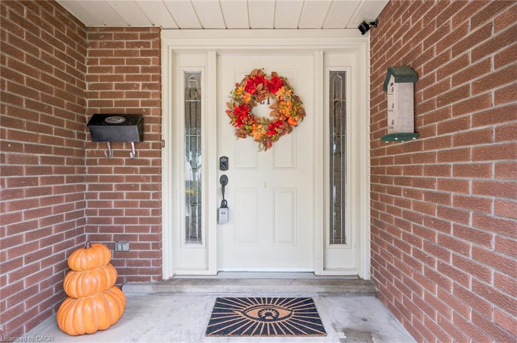 Brick exterior with a white entry door, side lites, and a black mailbox
