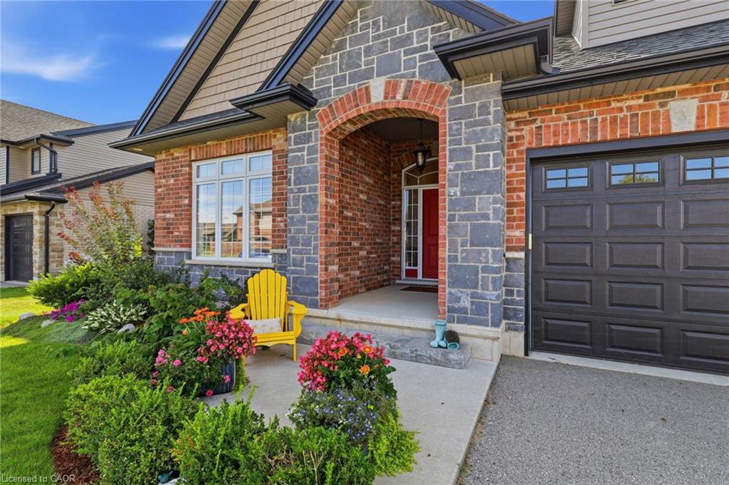 Brick and stone exterior with a dark paneled garage door