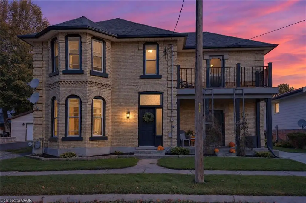 Brick exterior with a prominent bay window featuring arched lower windows