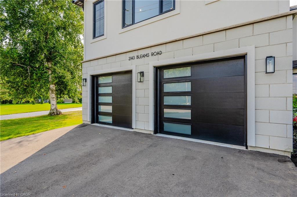 Two contemporary black garage doors with frosted glass panels
