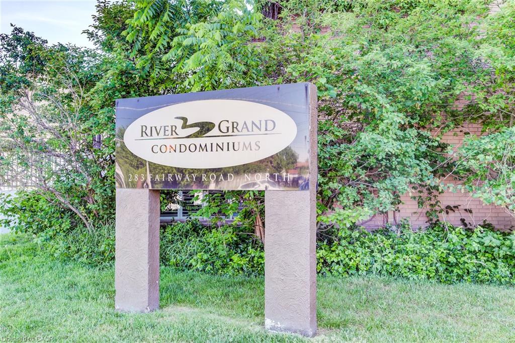 River Grand Condominiums signage with a dark, reflective surface and light-colored lettering