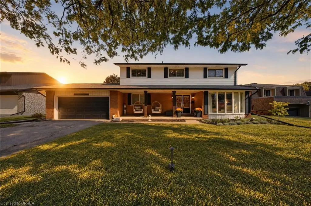 Brick and siding exterior with a two-car garage, front porch, and a bay window