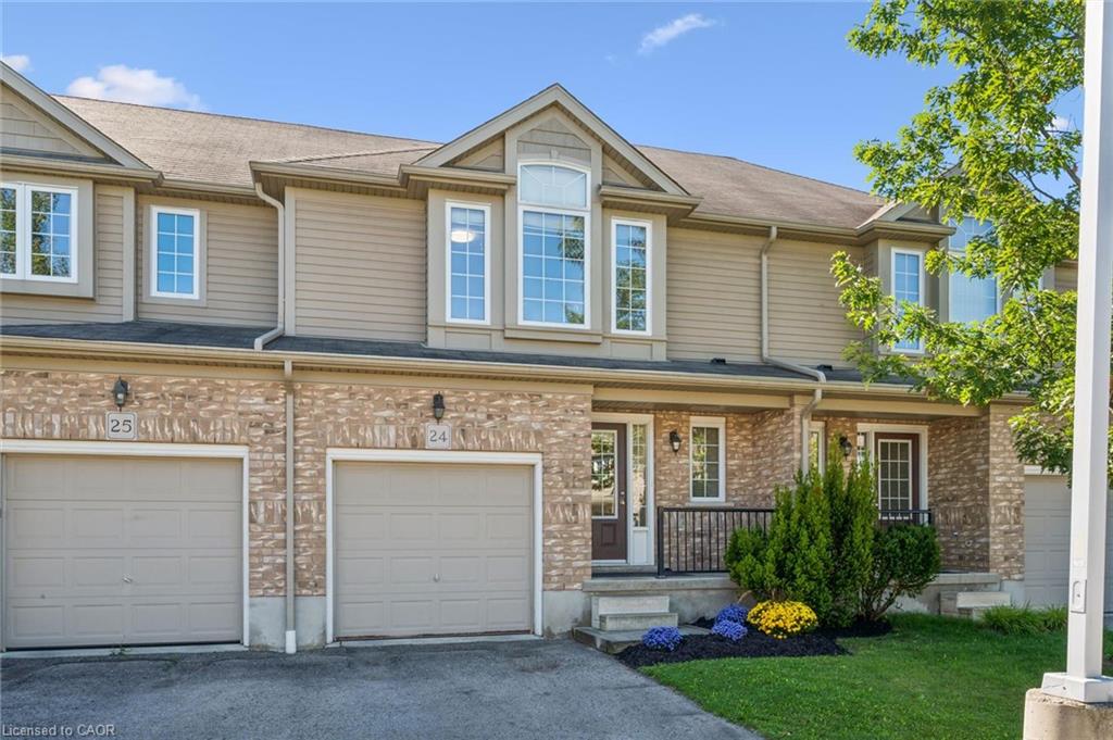 Brick and siding exterior with individual garages and front entrances