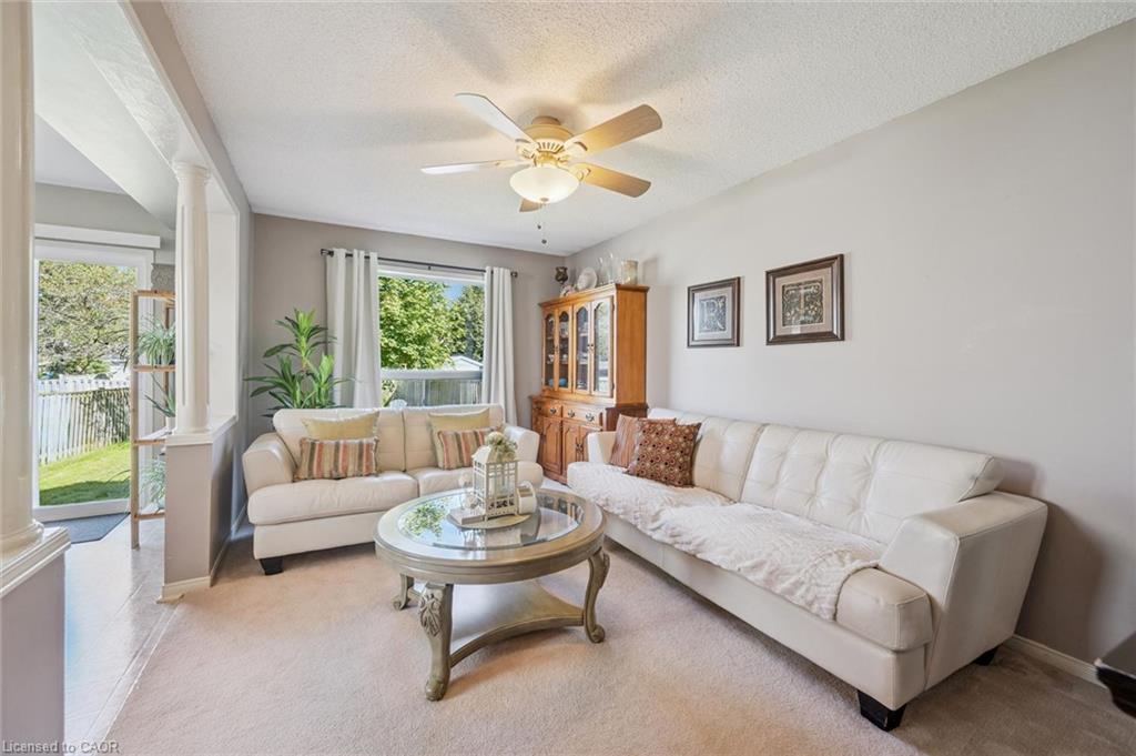 Neutral wall finishes, recessed lighting, and a ceiling fan with integrated lighting
