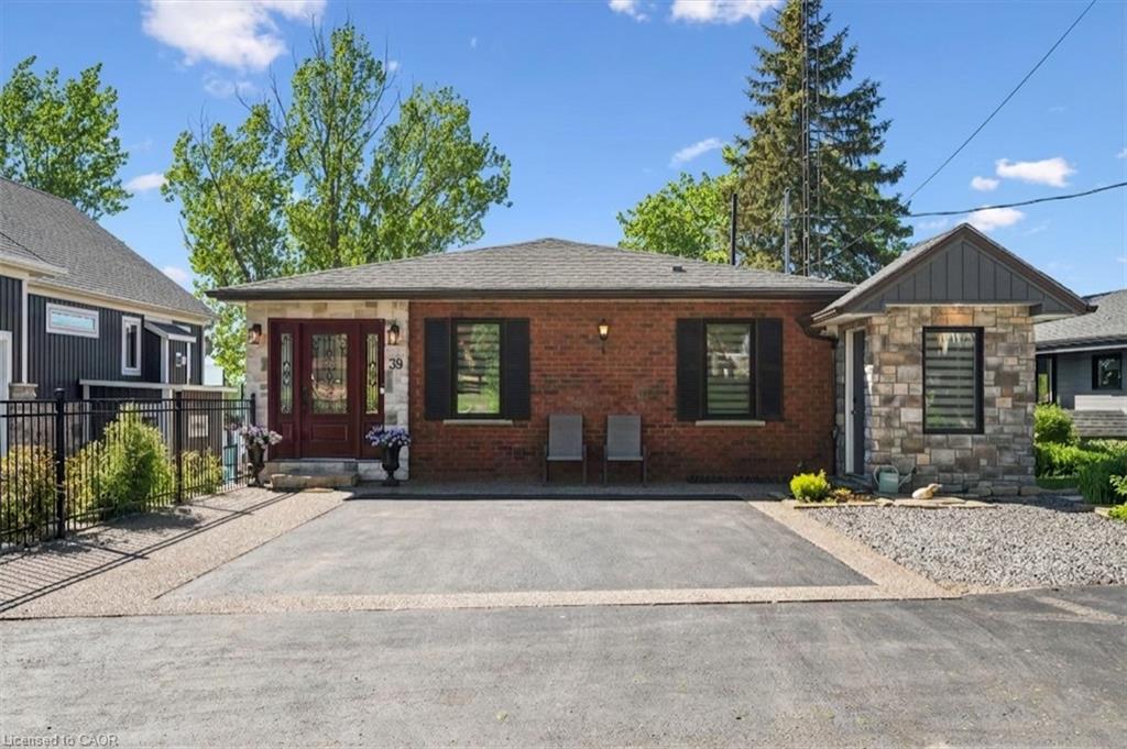 Brick and stone-clad exterior with a dark wood entry door featuring decorative glass
